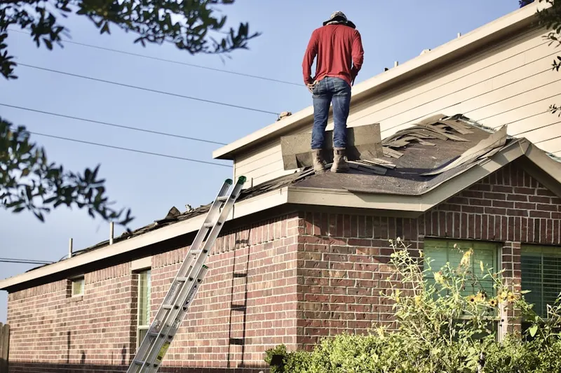 Professional roofer working on a residential roof in Spring Meadow